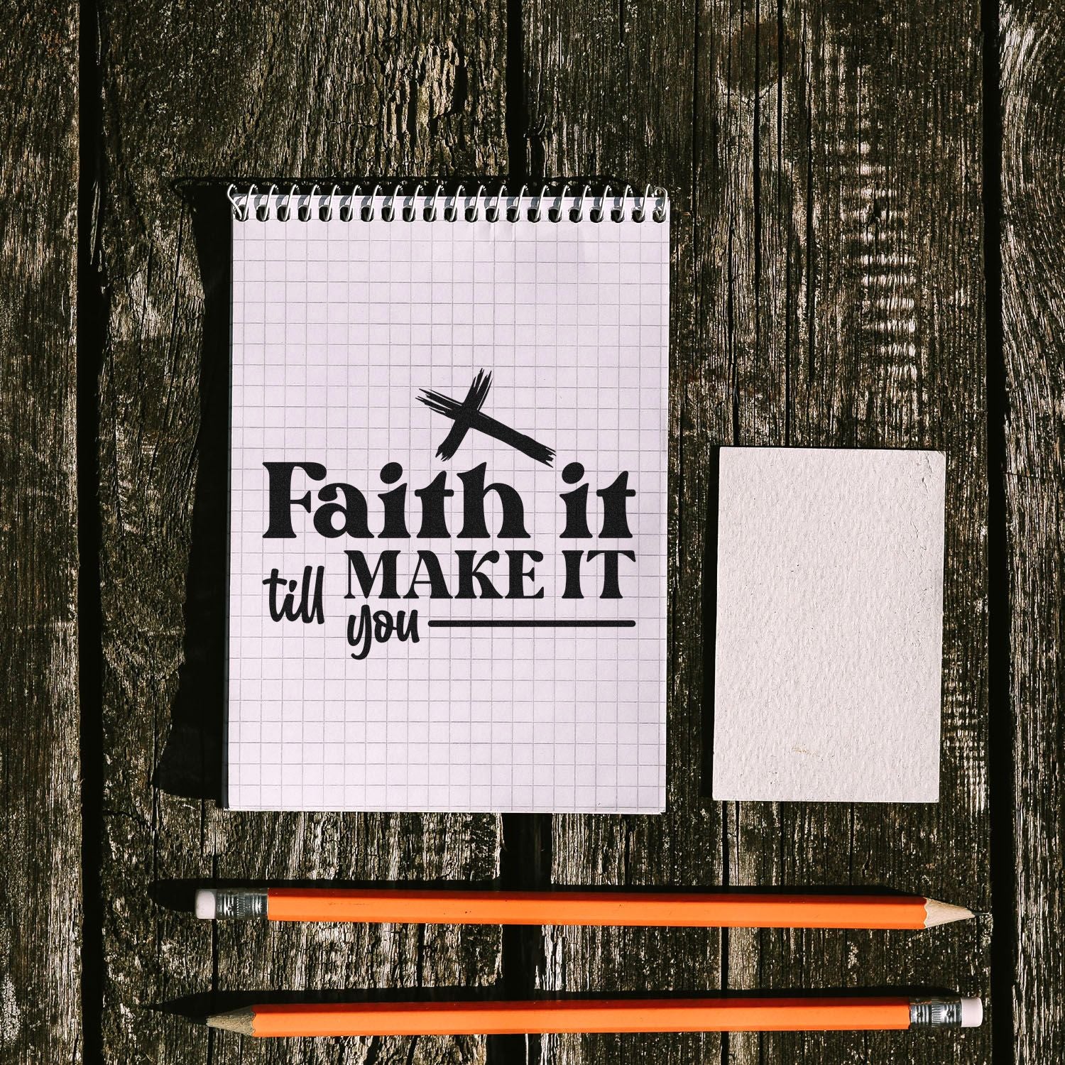 Christian faith rubber stamp quote on notebook paper, with pencils and a blank stamp block.