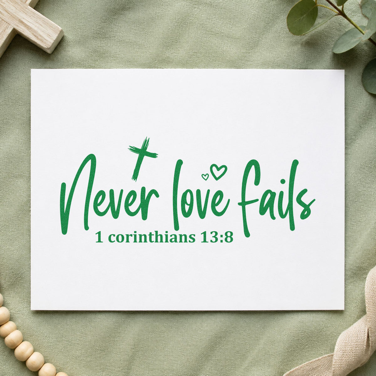 Never Love Fails craft stamp imprint in green ink on a handmade project, one idea being framed bedroom art.