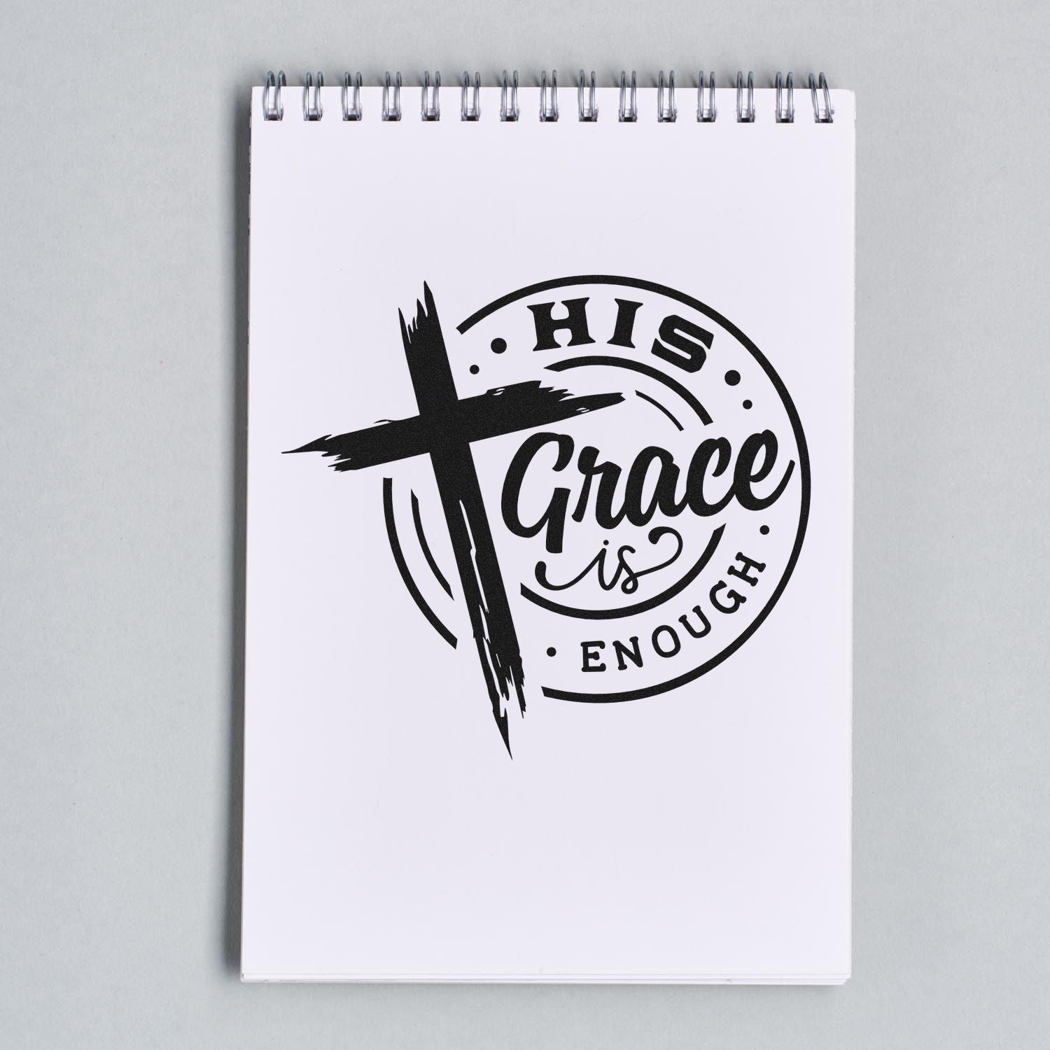 His Grace Is Enough Christian rubber stamp design with cross imprint on a notepad, ideal for faith-based crafts and journaling.