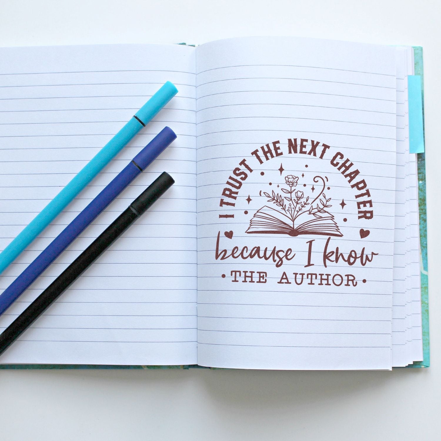 Inspirational rubber stamp for journaling: I trust the next chapter because I know the author with book and floral design.