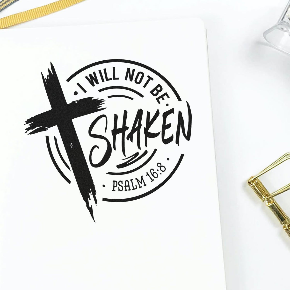 Vintage Pro I Will Not Be Shaken Badge Premium Wooden Stamp imprint stamped in black ink. A brushstroke cross overlaps a circular "I will not be shaken" design with Psalm 16:8.