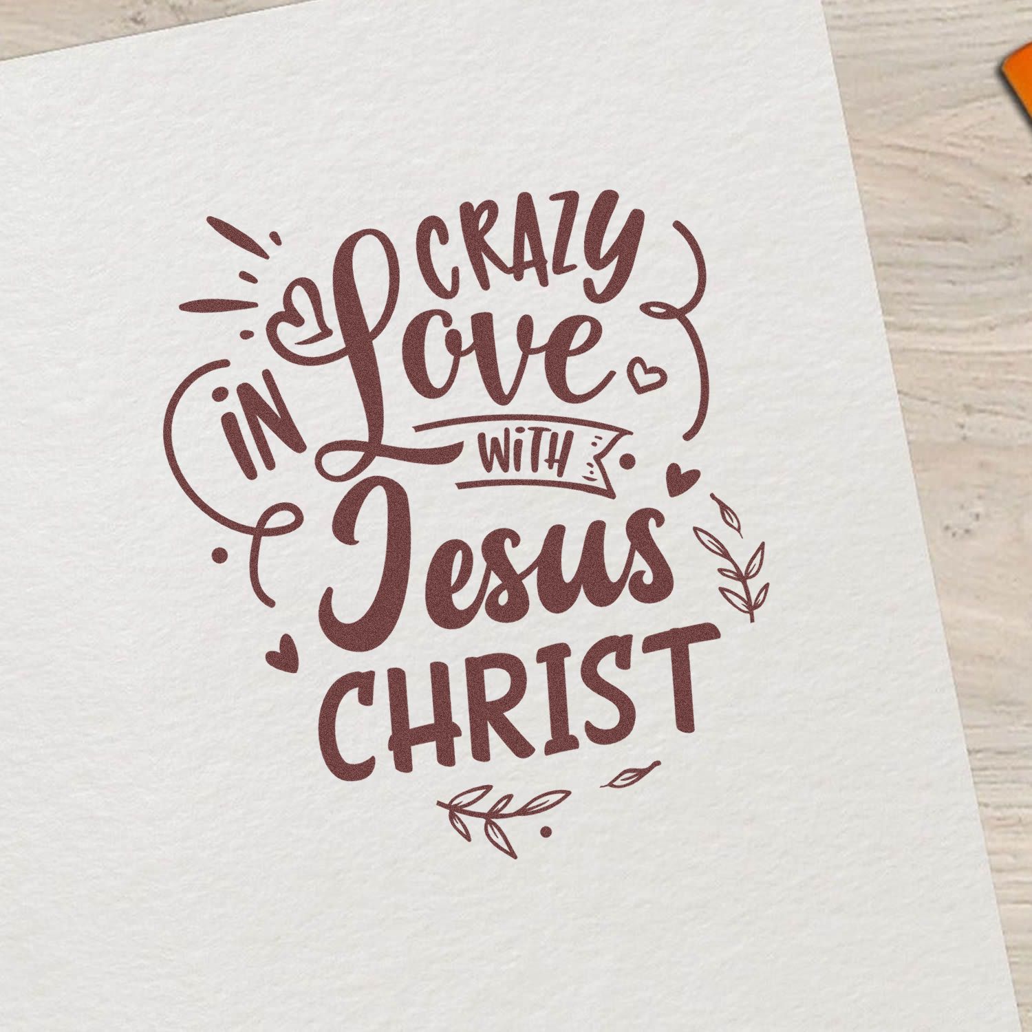 Christian rubber stamp design reading Crazy in Love with Jesus Christ with hearts and leaves on paper.
