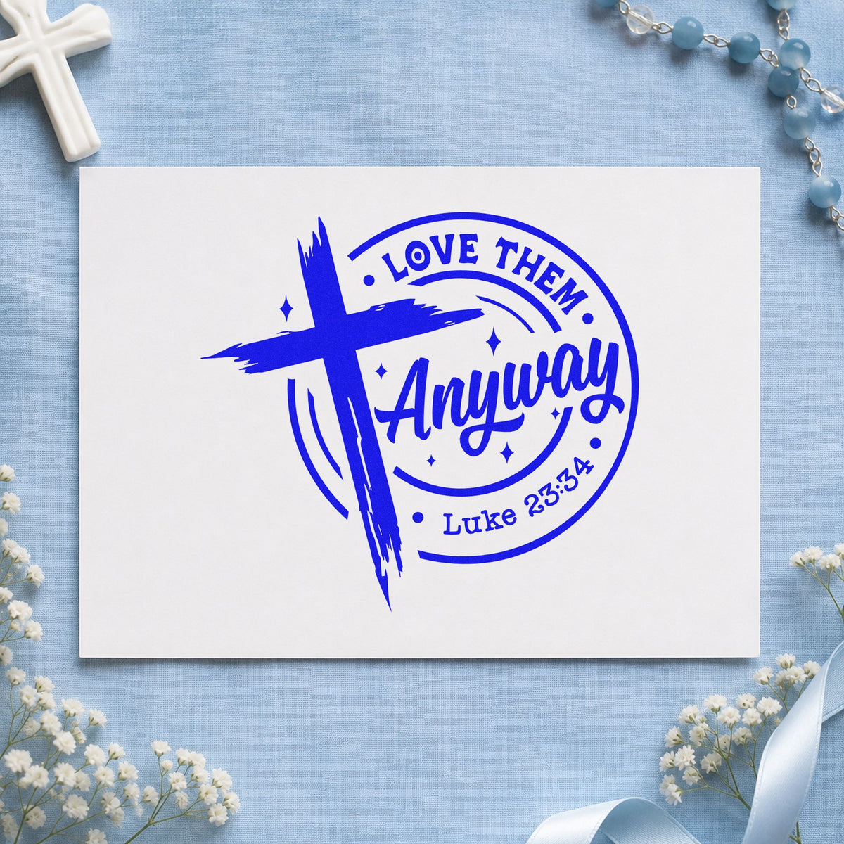 Love Them Anyway craft stamp in blue ink on cardstock, an easy option for prison ministry tees.