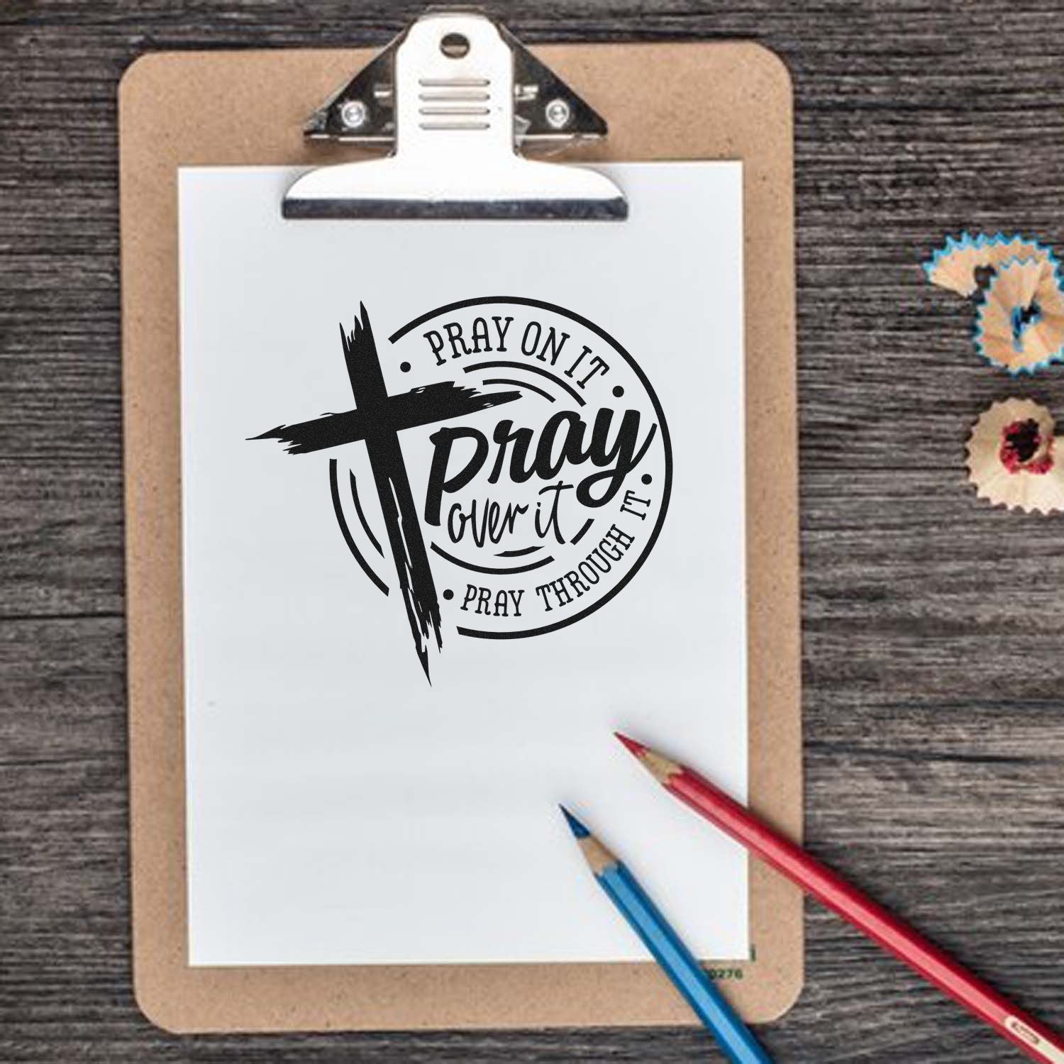 Christian rubber stamp design with cross and prayer quote: Pray on it, pray over it, pray through it on clipboard.