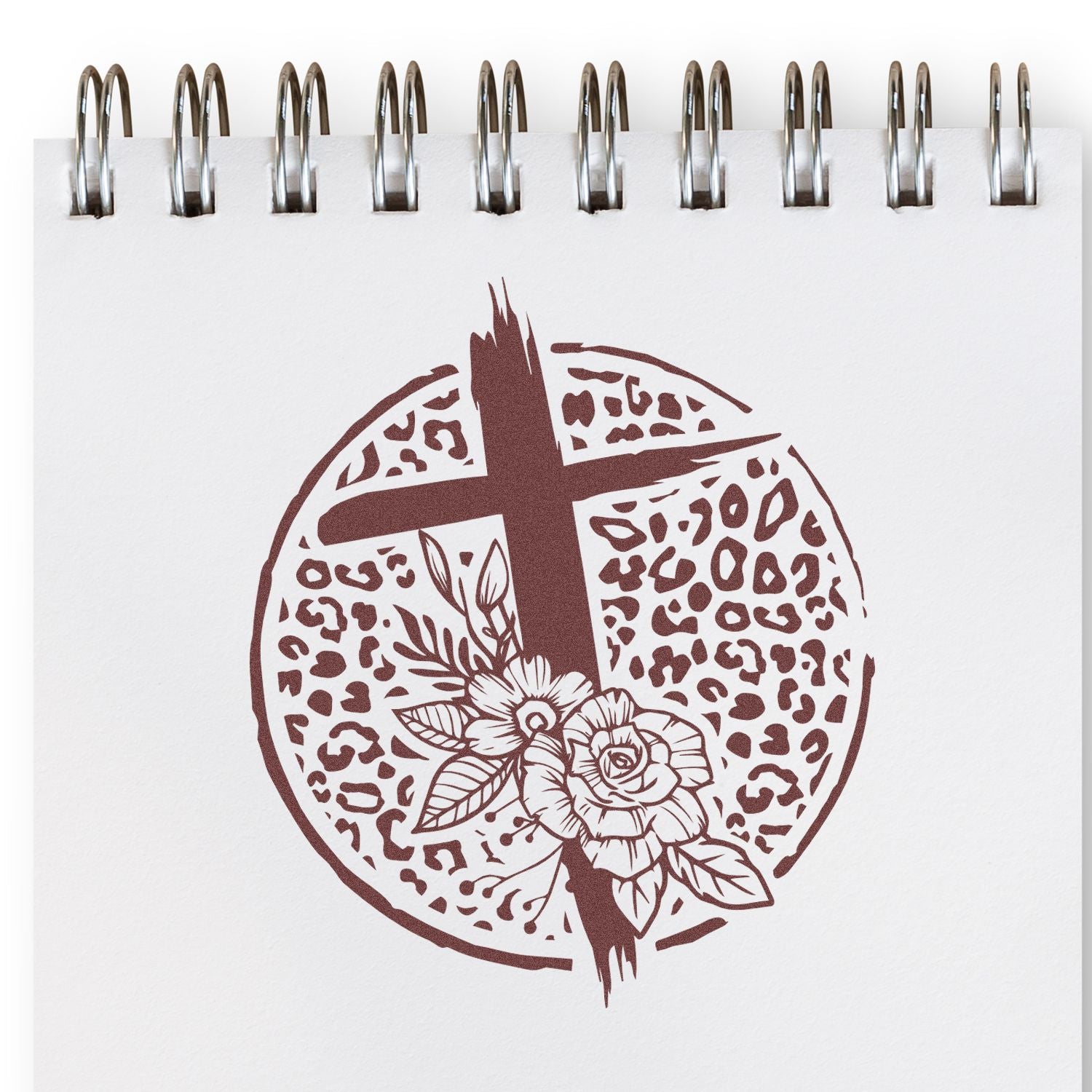 Christian floral cross rubber stamp design with leopard print circle on notebook page, ideal for faith-based crafts.