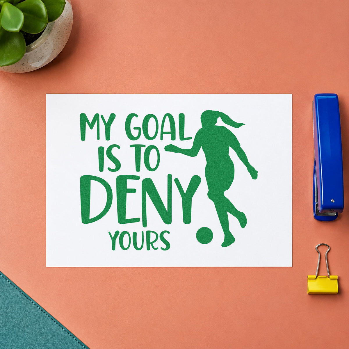 My Goal Is to Deny Yours craft stamp imprint in green ink on a handmade project, one idea being clean sheet pages.