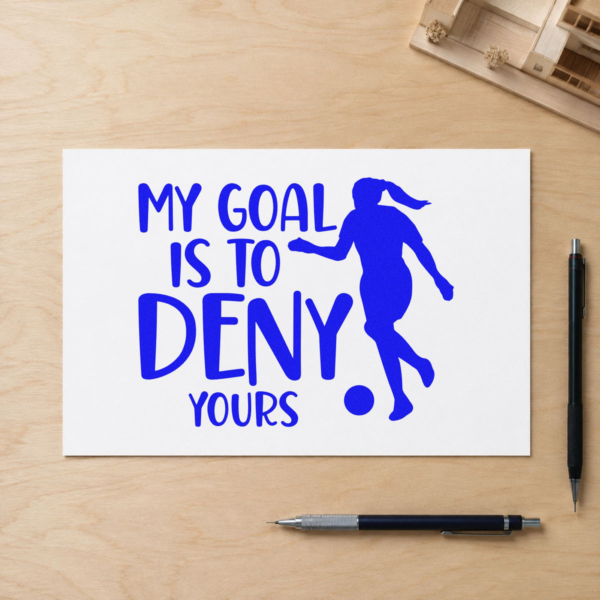 My Goal Is to Deny Yours craft stamp imprinted in blue ink on paper, a design suited to club sticker sheets.