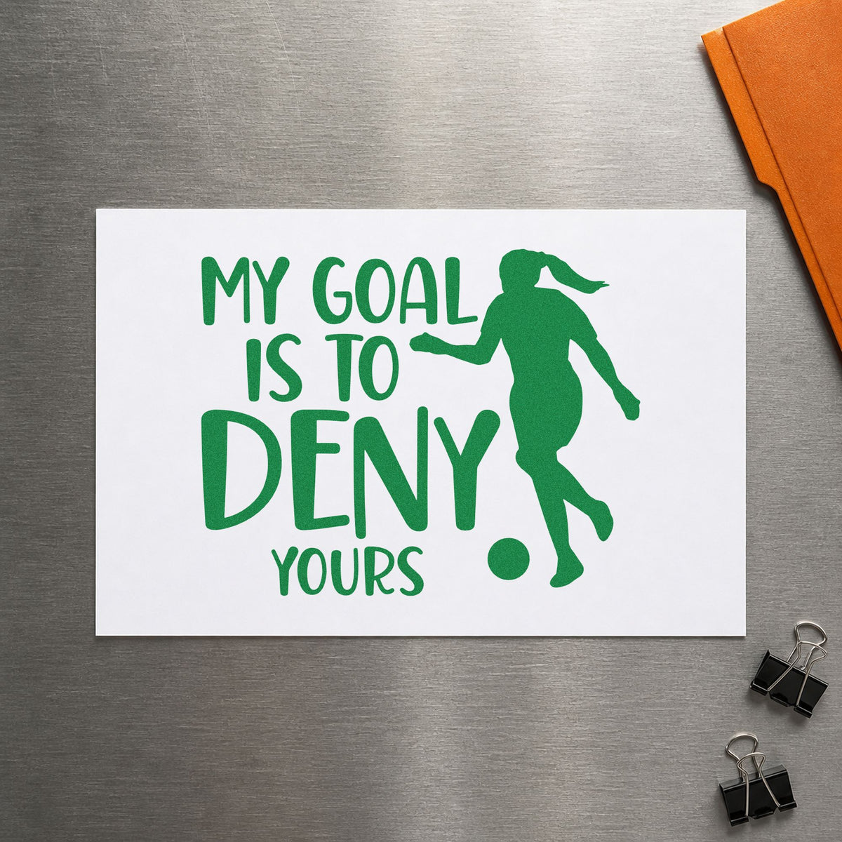 My Goal Is to Deny Yours craft stamp imprint in green ink on a handmade project, one idea being framed trophy shelf.