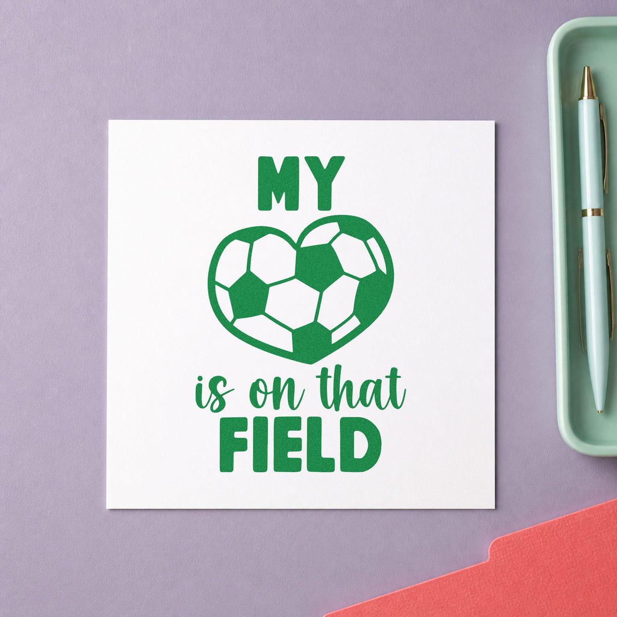Soccer Heart on That Field craft stamp imprint in green ink on a handmade project, one idea being memory box pages.