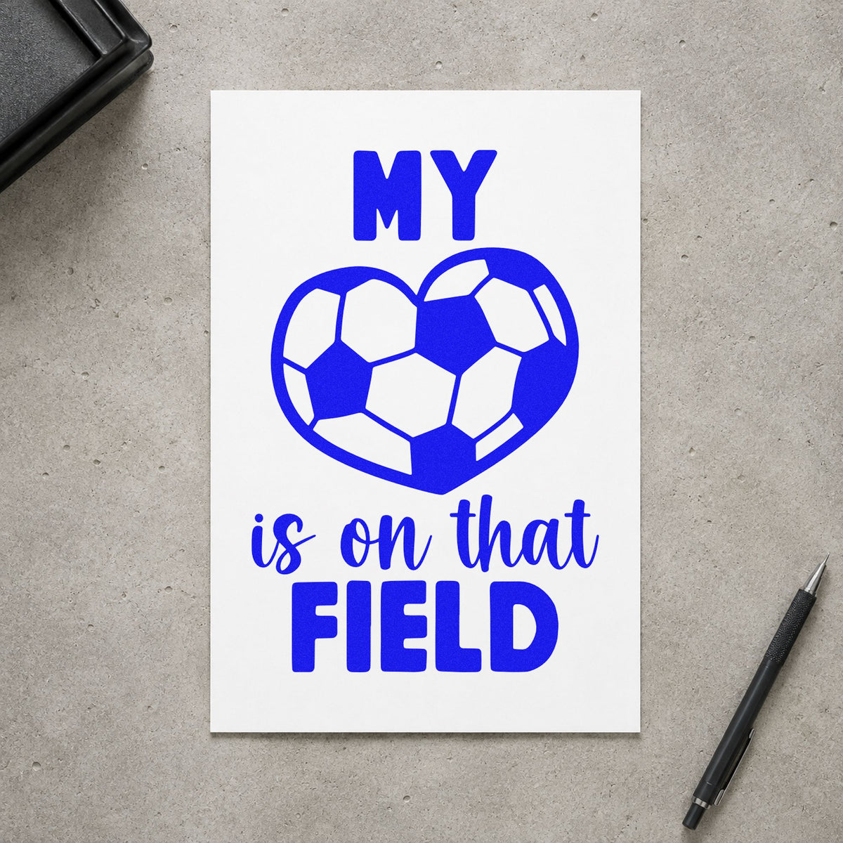 Soccer Heart on That Field craft stamp imprinted in blue ink on paper, a design suited to scholarship announcement.