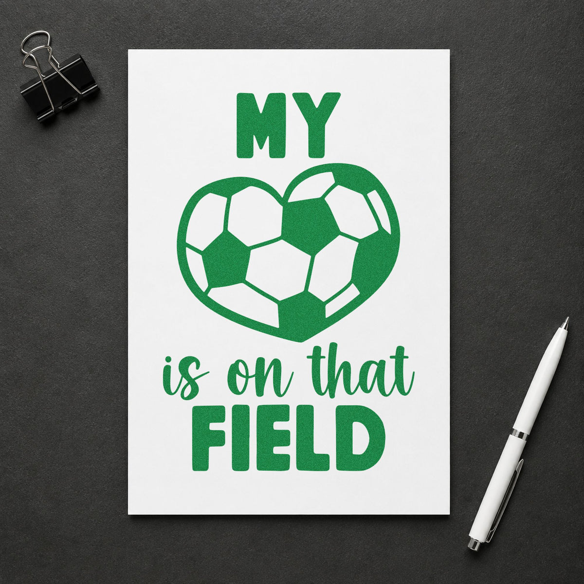 Soccer Heart on That Field craft stamp imprint in green ink on a handmade project, one idea being framed jersey case.