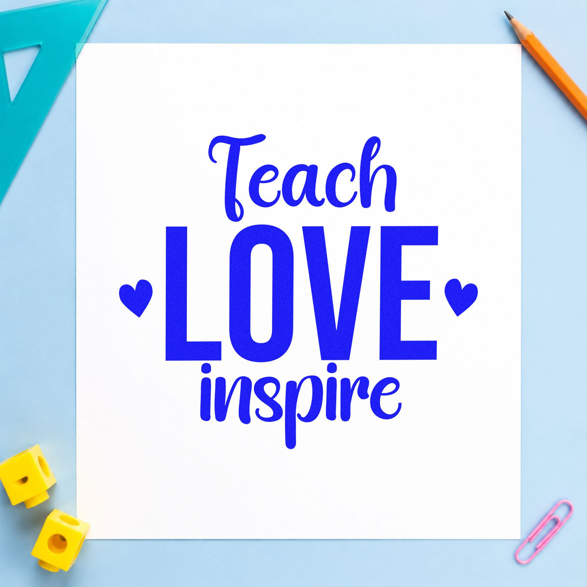 Teach Love Inspire craft stamp imprinted in blue ink on paper, a design suited to snack drawer labels.