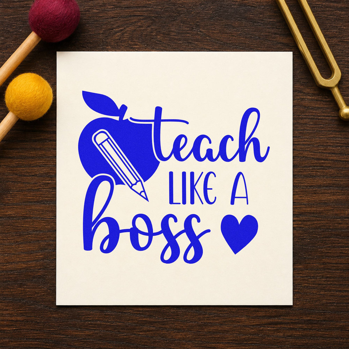 Teach Like a Boss craft stamp imprinted in blue ink on paper, a design suited to coffee cart bands.