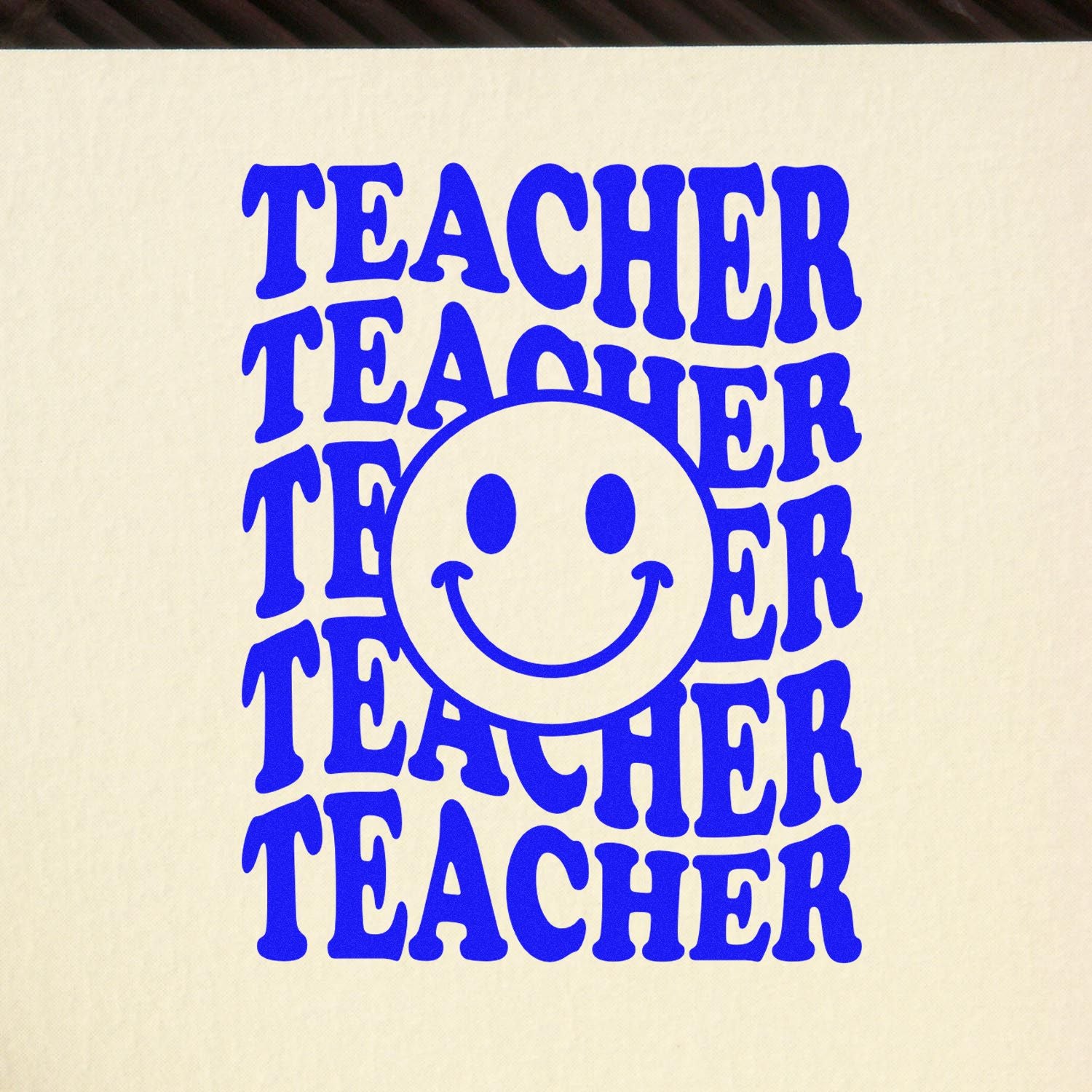Teacher rubber stamp design with smiley face and repeated bold blue text for classroom rewards, crafts, and school branding.