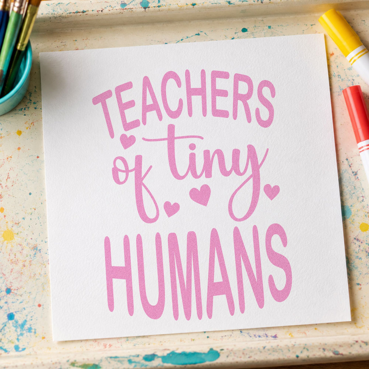 Teachers of Tiny Humans craft stamp in purple ink on cardstock, an easy option for graduation cap tags.