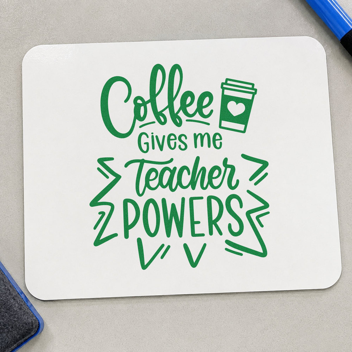 Coffee Gives Teacher Powers craft stamp imprint in green ink on a handmade project, one idea being framed comic wall.