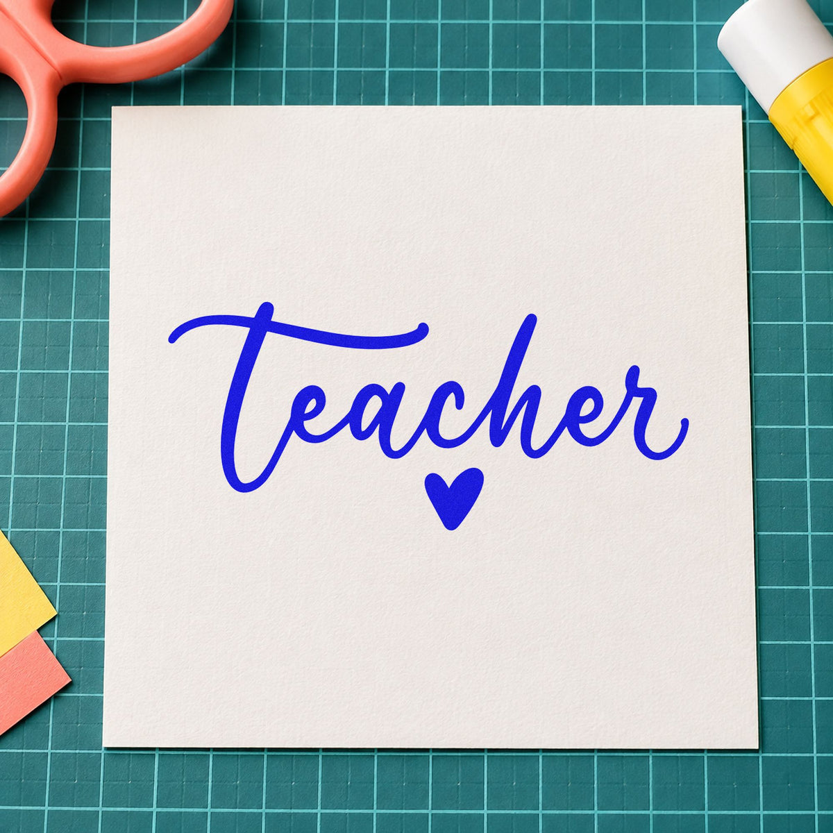 Teacher Script Heart craft stamp in blue ink on cardstock, an easy option for ribbon trim panels.