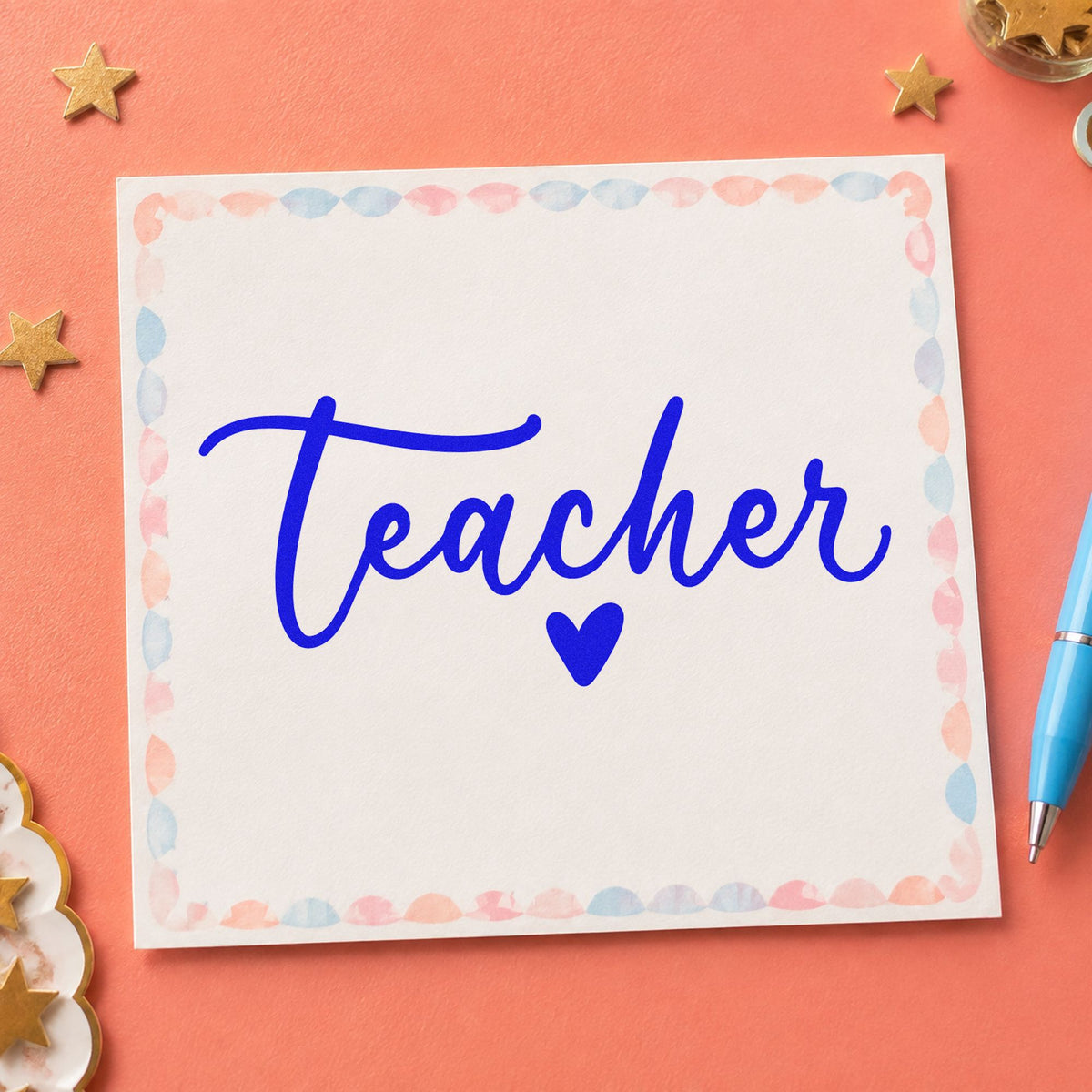 Teacher Script Heart craft stamp imprinted in blue ink on paper, a design suited to return address labels.