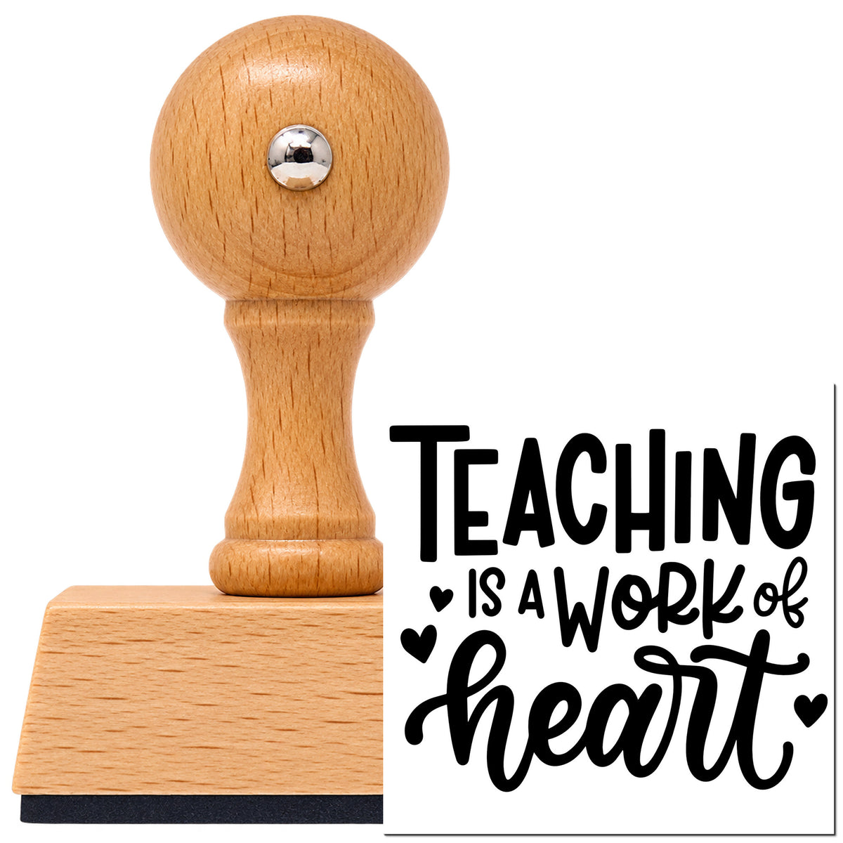 Teaching Is A Work Of Heart Vintage Pro rubber stamp in European beech wood with a round knob handle, shown beside its black imprint.