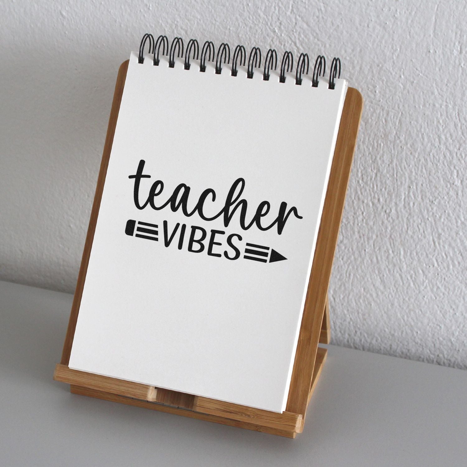 Teacher Vibes rubber stamp design on a spiral notebook display, perfect for classroom gifts and craft projects.