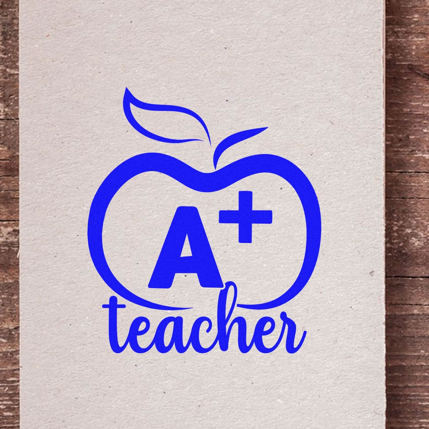 A+ teacher apple rubber stamp design with blue outline apple icon, ideal for classroom grading and educator crafts.