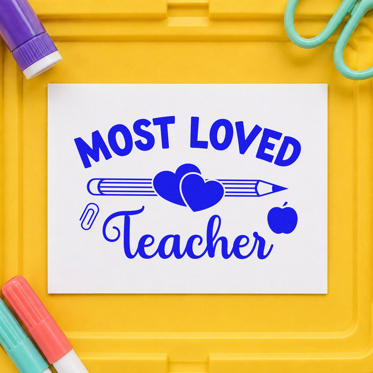 Most Loved Teacher craft stamp imprinted in blue ink on paper, a design suited to gift pile labels.