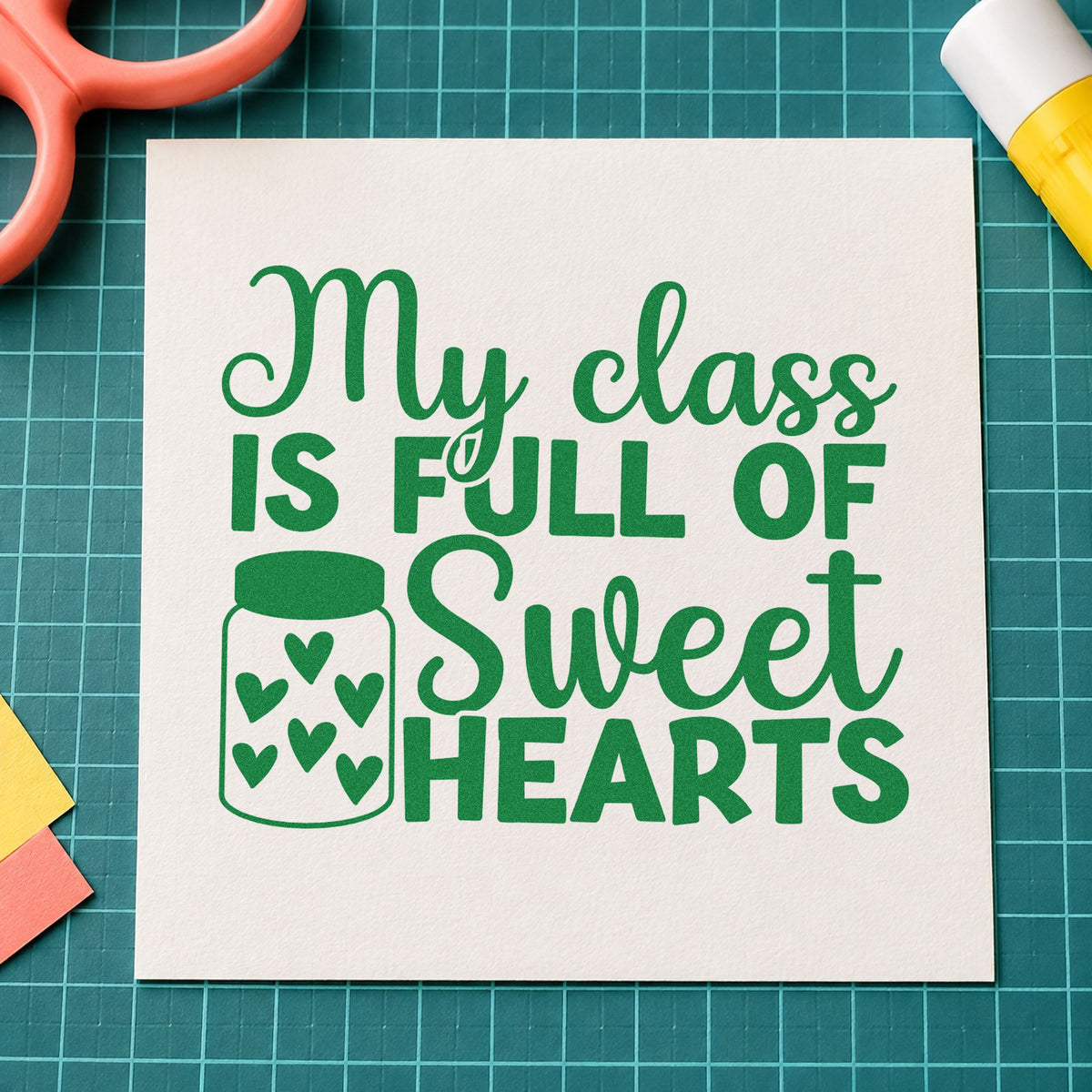 My Class Is Full of Sweethearts craft stamp imprint in green ink on a handmade project, one idea being framed bulletin board.