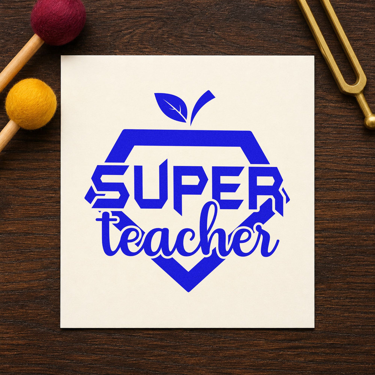Super Teacher Shield craft stamp imprinted in blue ink on paper, a design suited to iron-on patch seals.