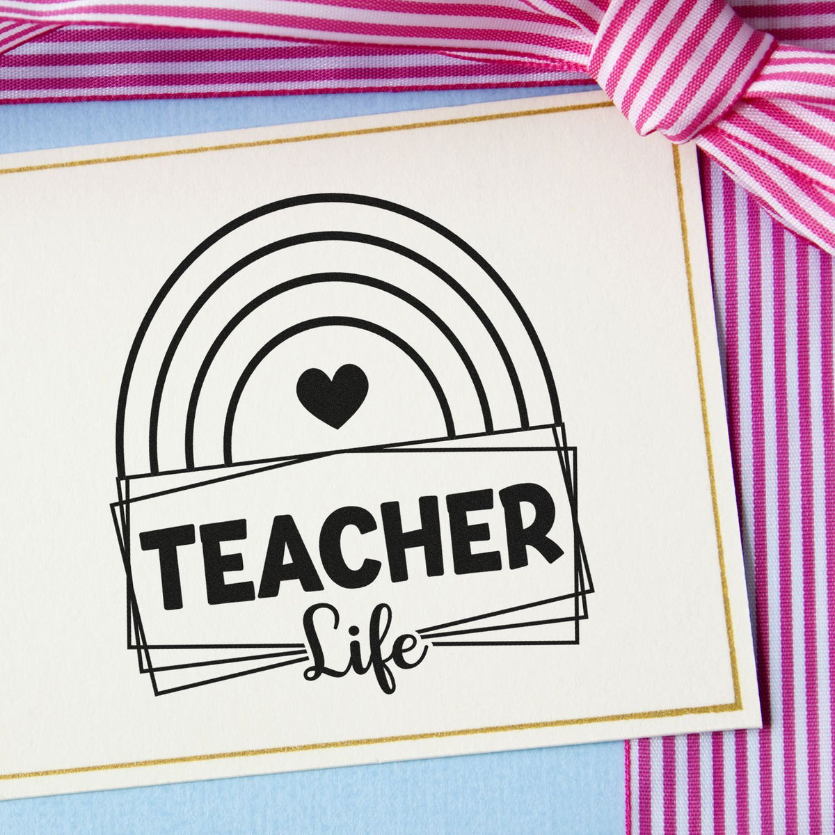 Teacher Life Rainbow Framed Lettering Premium Wooden Stamp - Vintage Pro imprint stamped in black ink. A rainbow and solid heart top overlapping rectangular frames reading "Teacher life."