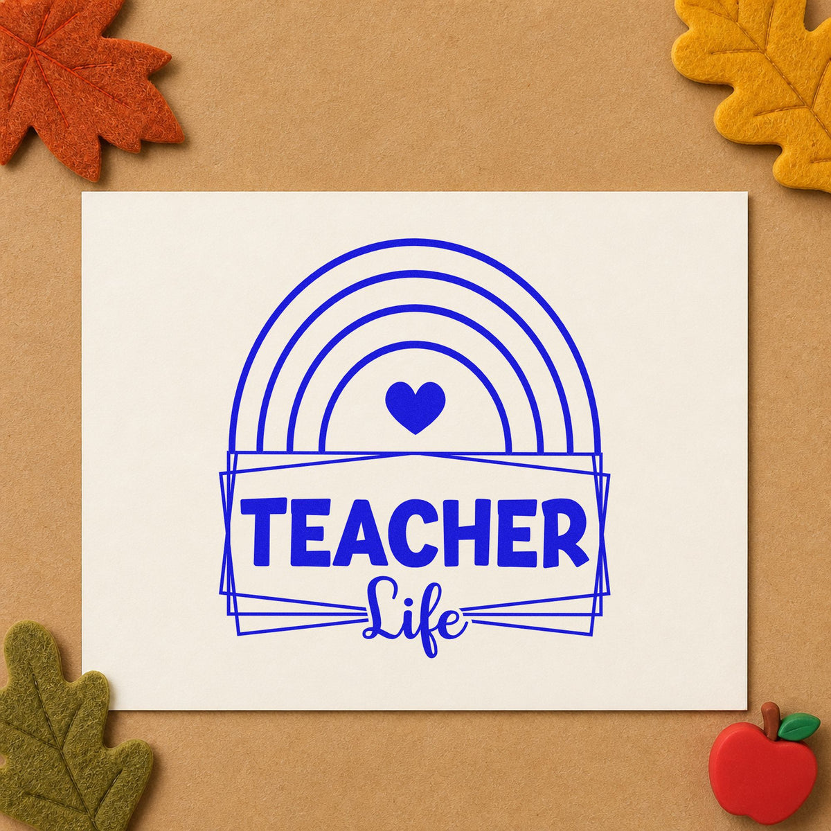 Teacher Life Rainbow Frame craft stamp imprinted in blue ink on paper, a design suited to window cling seals.