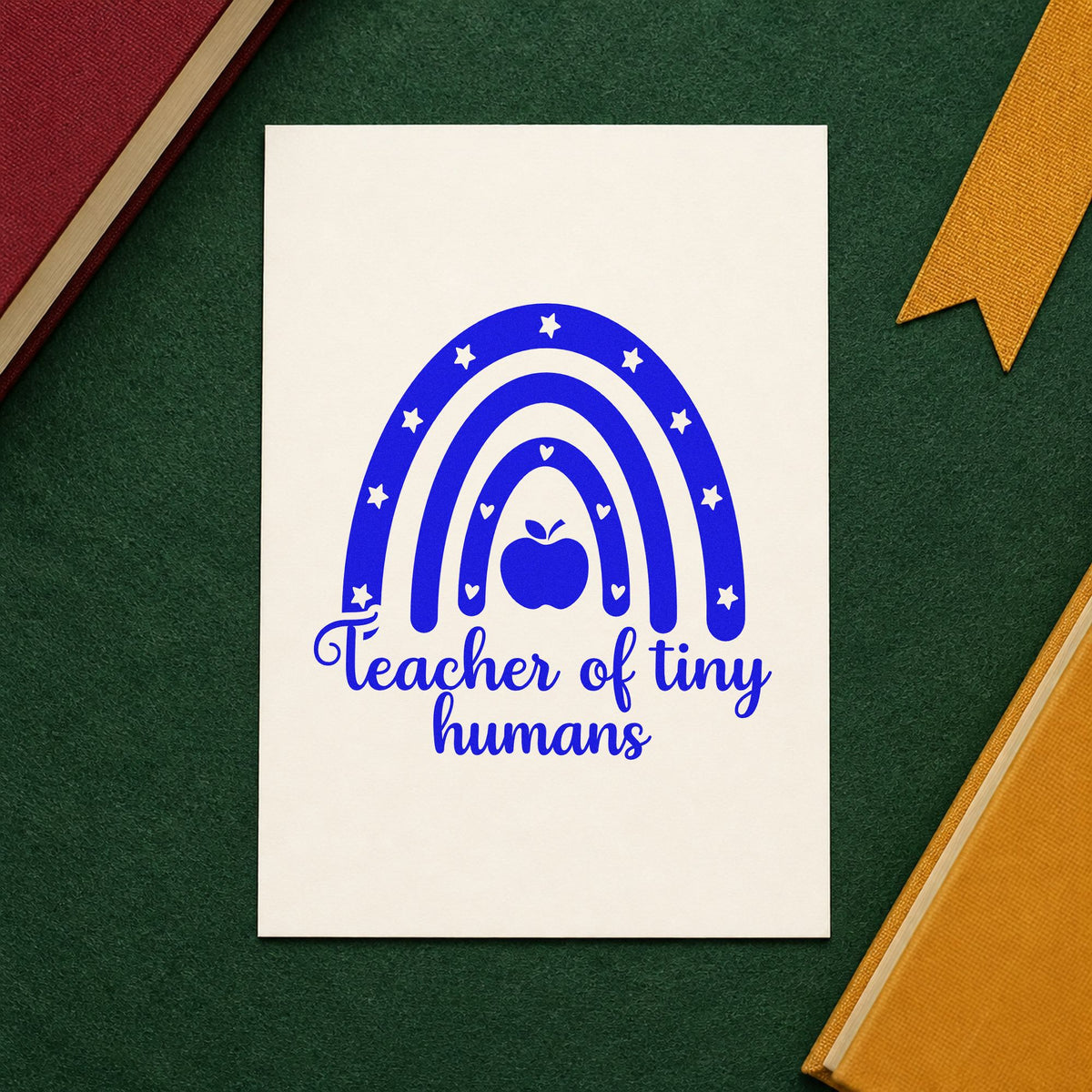 Teacher of Tiny Humans Rainbow craft stamp imprinted in blue ink on paper, a design suited to cubby hook seals.