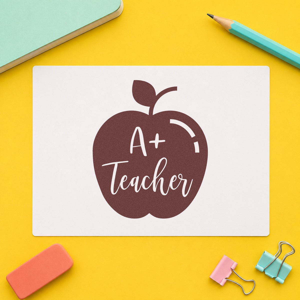 A Plus Teacher Solid Apple rubber stamp printed in brown ink, ready for revision box labels and similar paper crafts.
