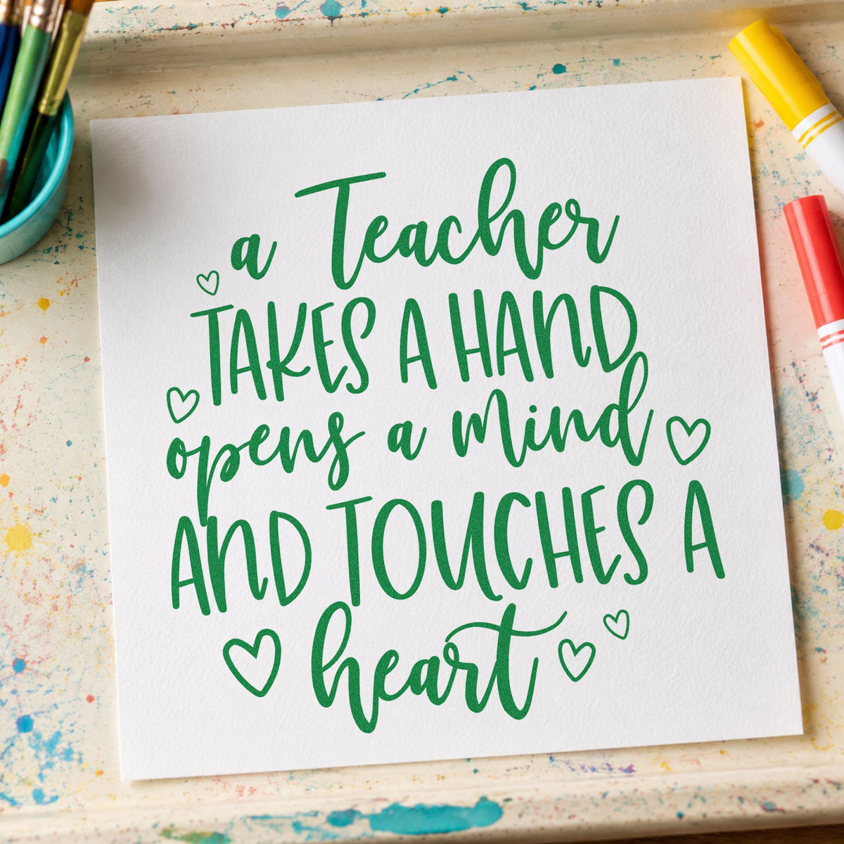 Teacher Takes a Hand craft stamp imprint in green ink on a handmade project, one idea being coloring heart pages.