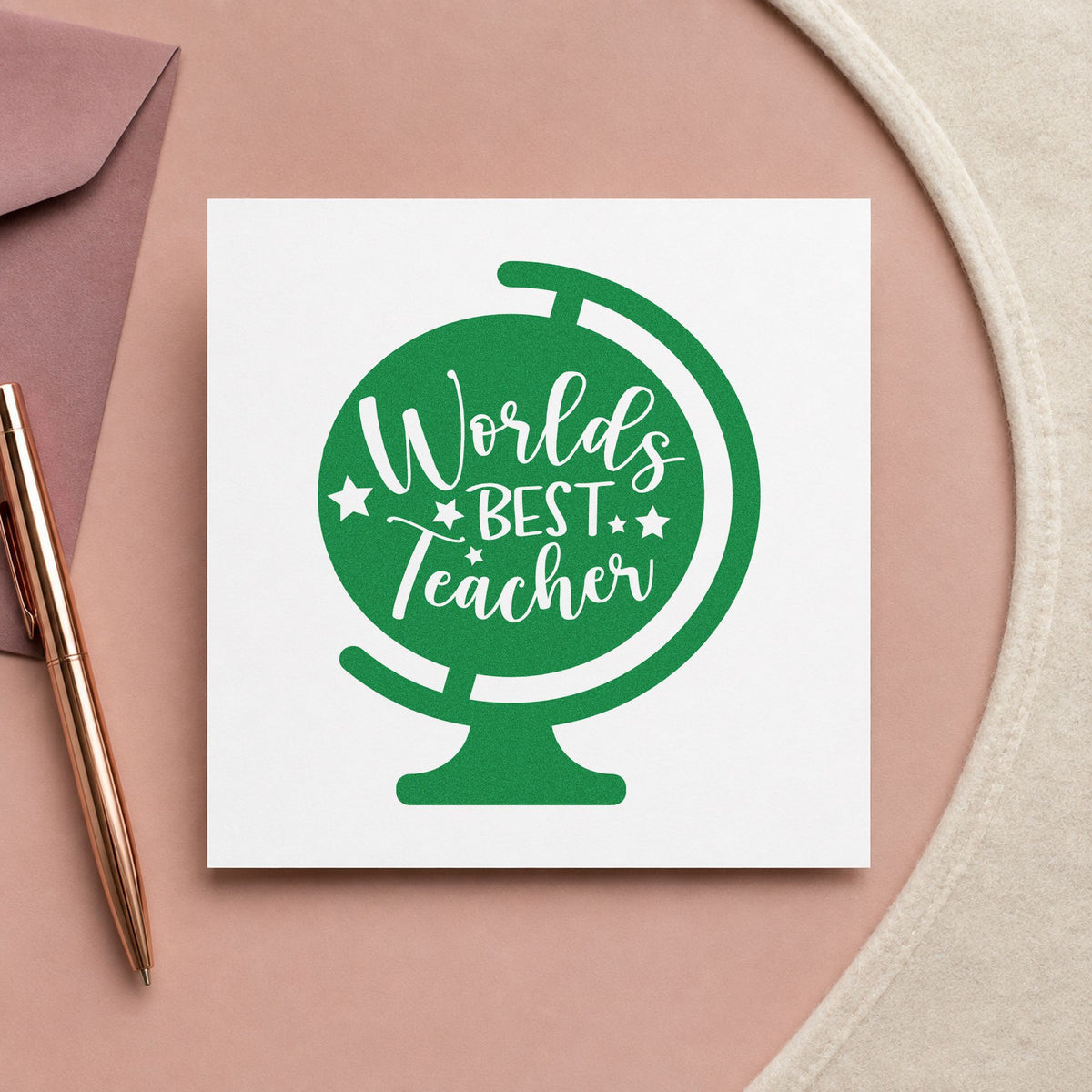World's Best Teacher Tilted Globe craft stamp imprint in green ink on a handmade project, one idea being framed travel wall.