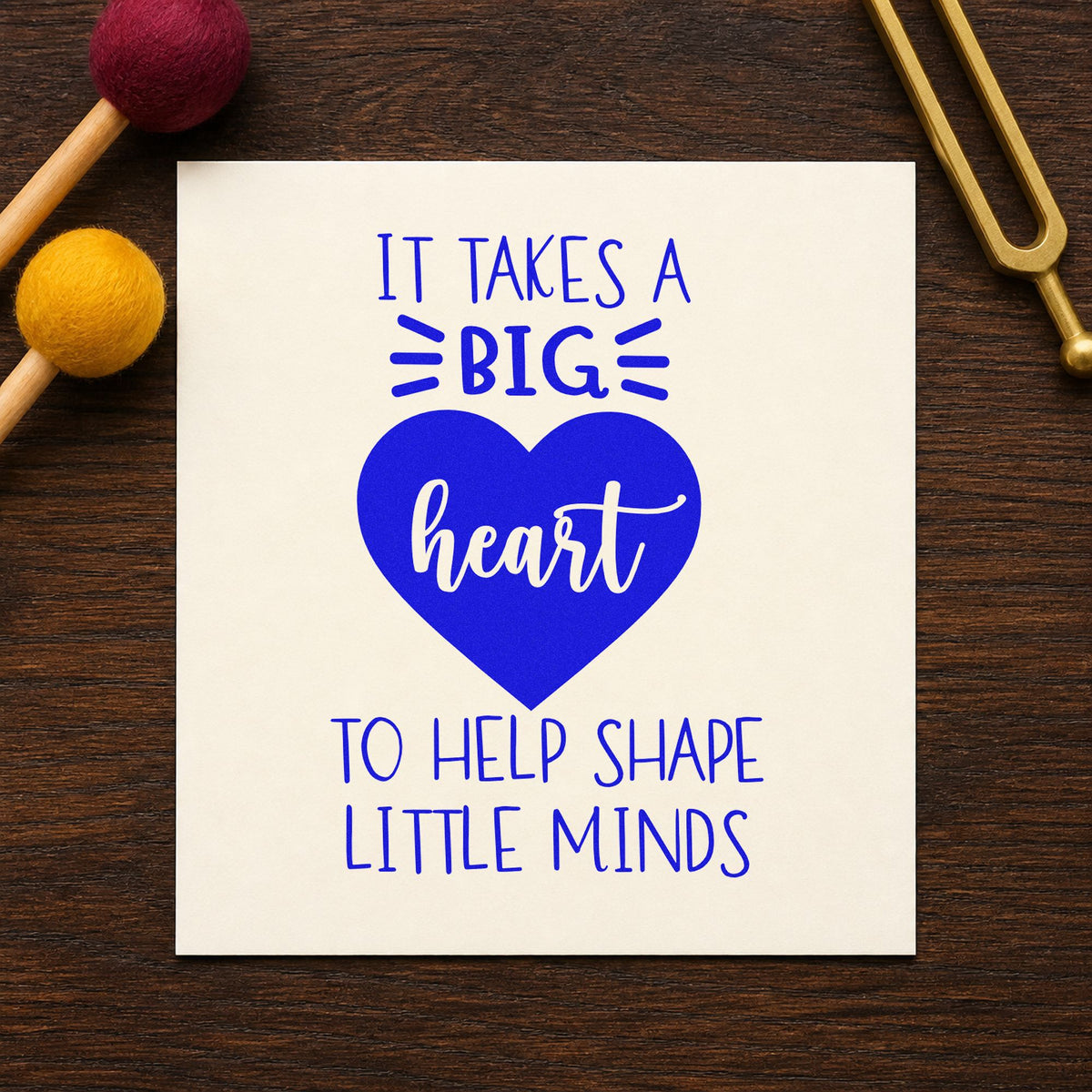 Big Heart Helps Little Minds craft stamp imprinted in blue ink on paper, a design suited to pram blanket seals.