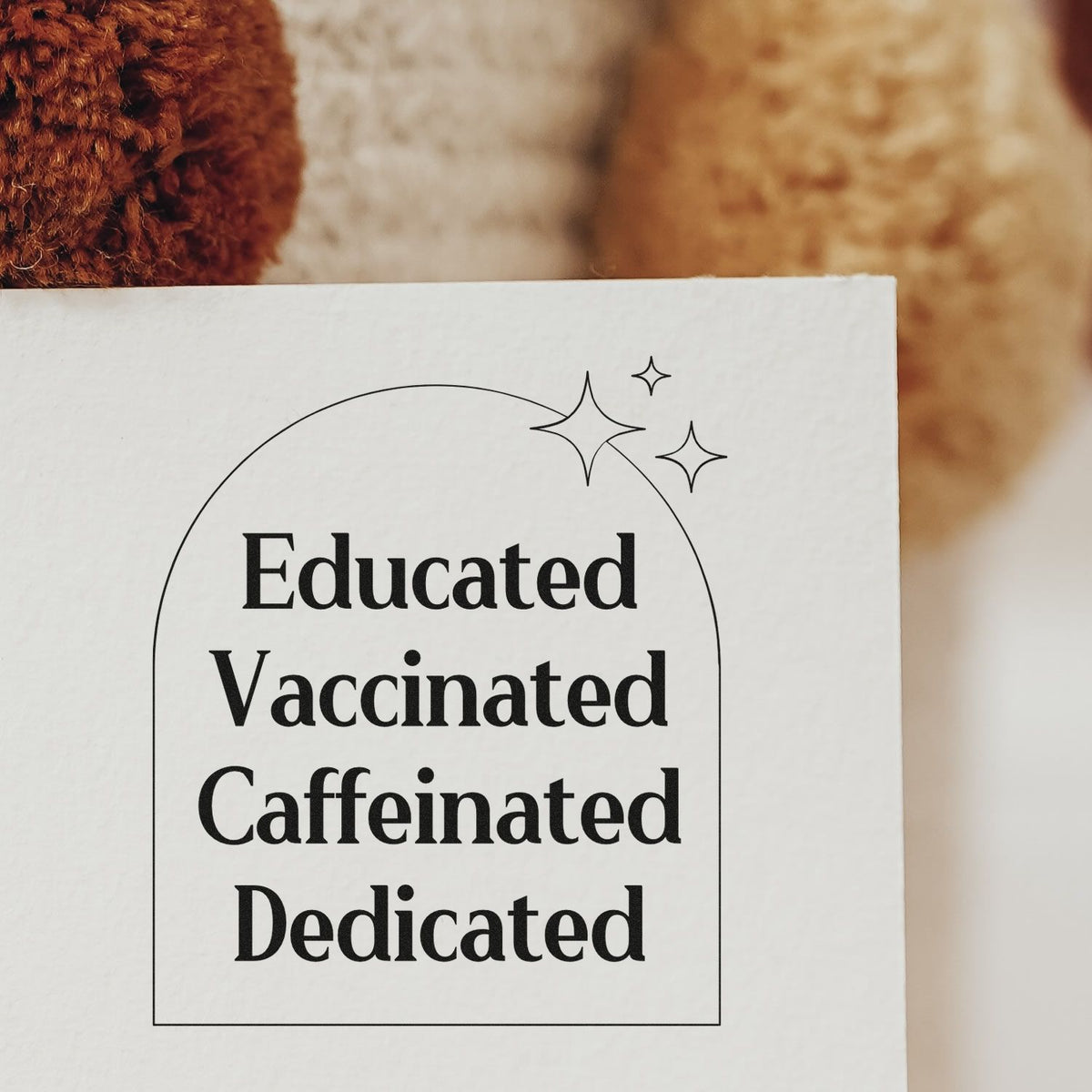 Premium Wooden Educated Vaccinated Caffeinated Dedicated With Sparkles Stamp - Vintage Pro imprint stamped in black ink. Four stacked words sit inside an arched outline accented by sparkles.