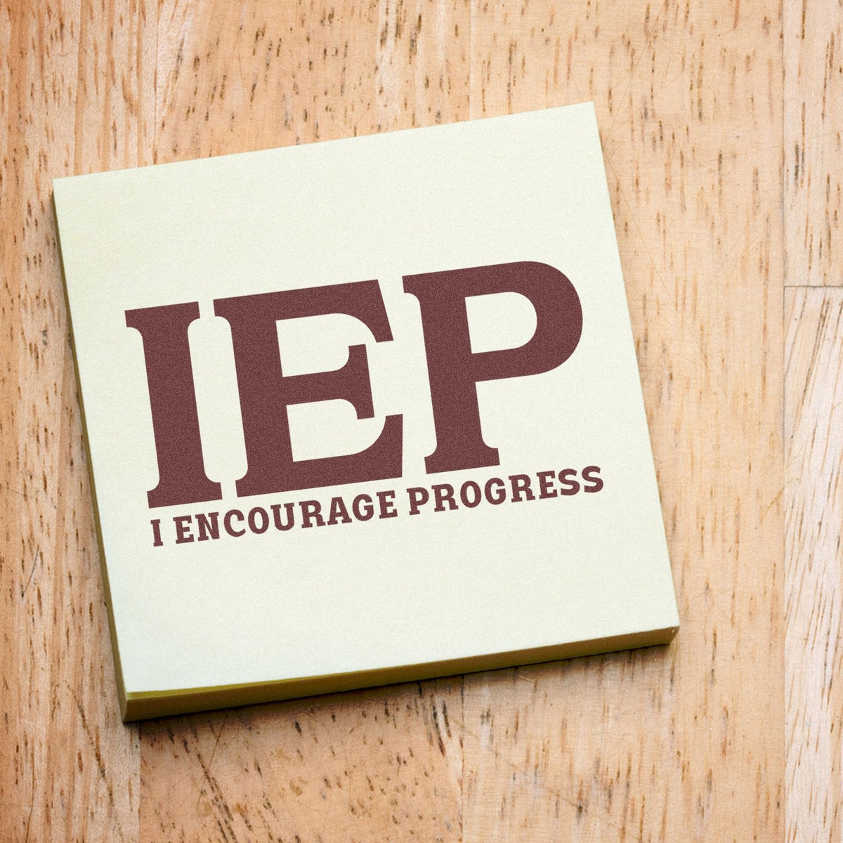 IEP I Encourage Progress rubber stamp shown in brown ink, stamped for projects such as review meeting tags.