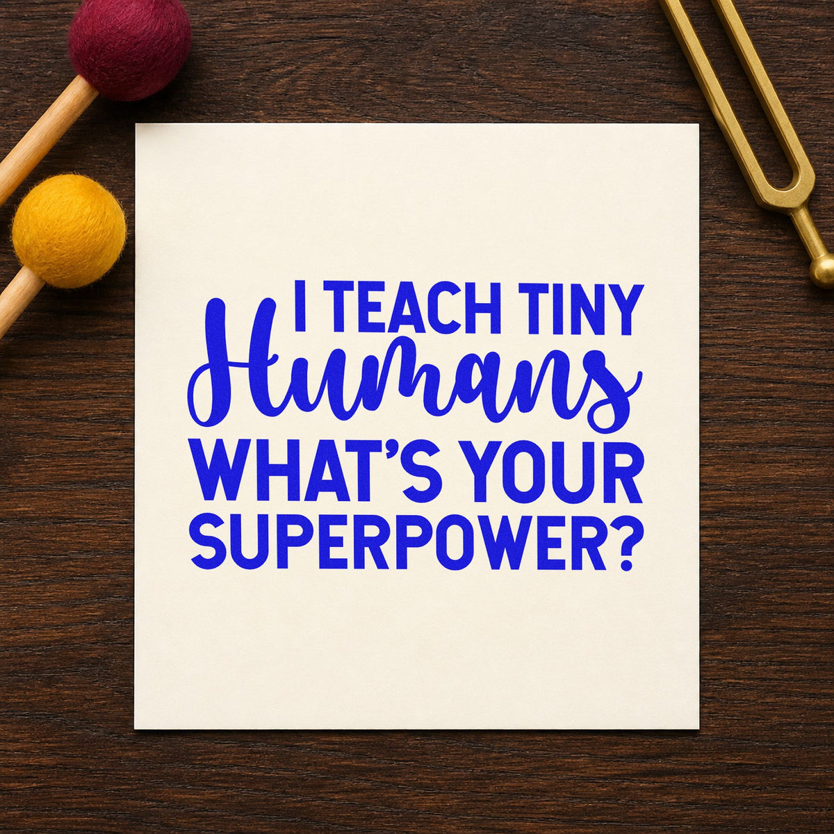 I Teach Tiny Humans craft stamp imprinted in blue ink on paper, a design suited to wristband seals.