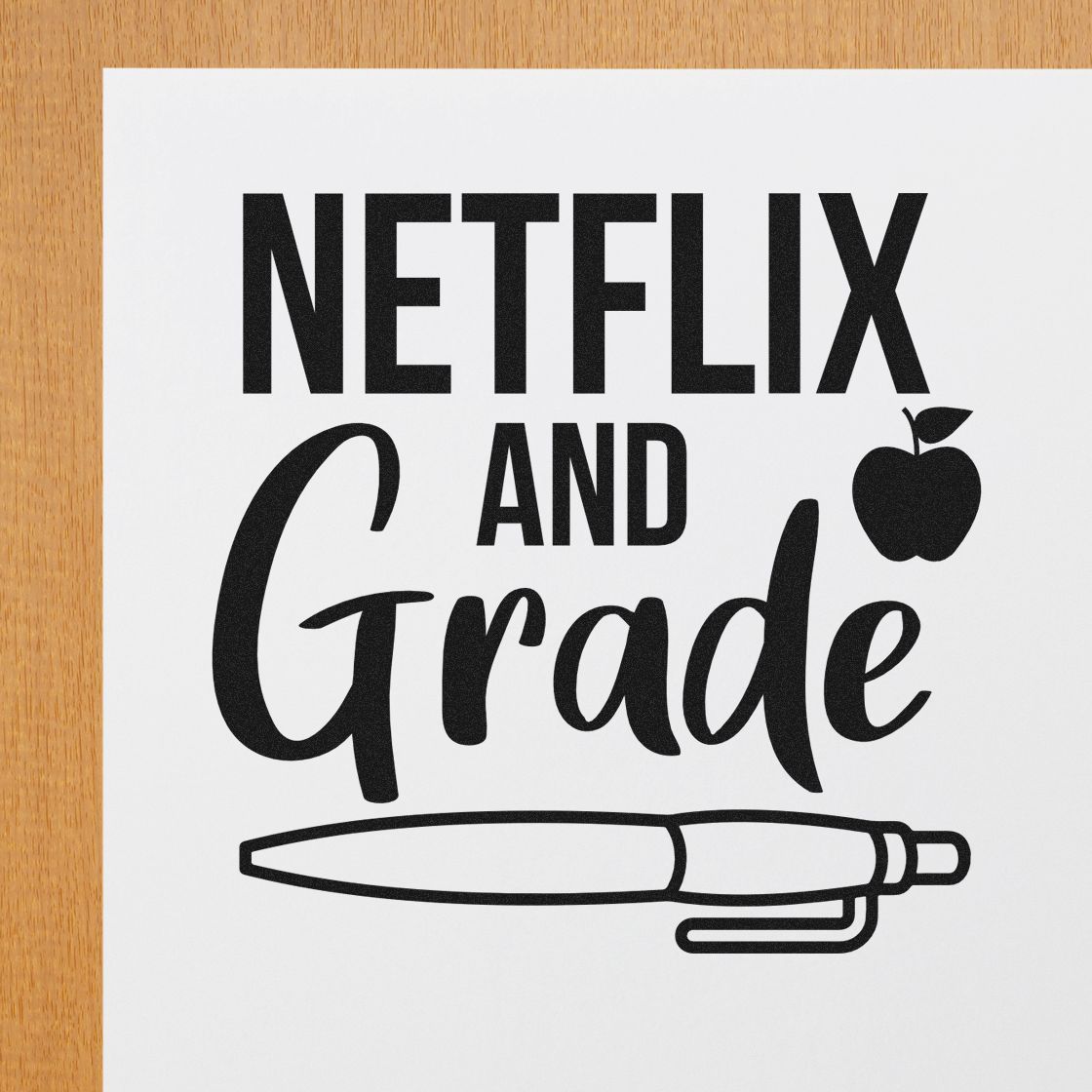 Premium Wooden Netflix And Grade Apple And Pen Stamp - Vintage Pro imprint stamped in black ink. An apple accents "Netflix and Grade" above a large horizontal pen.