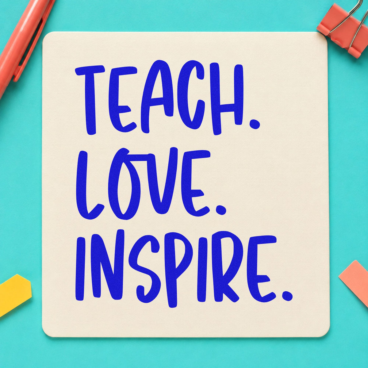 Teach Love Inspire Capitals craft stamp imprinted in blue ink on paper, a design suited to print room seals.