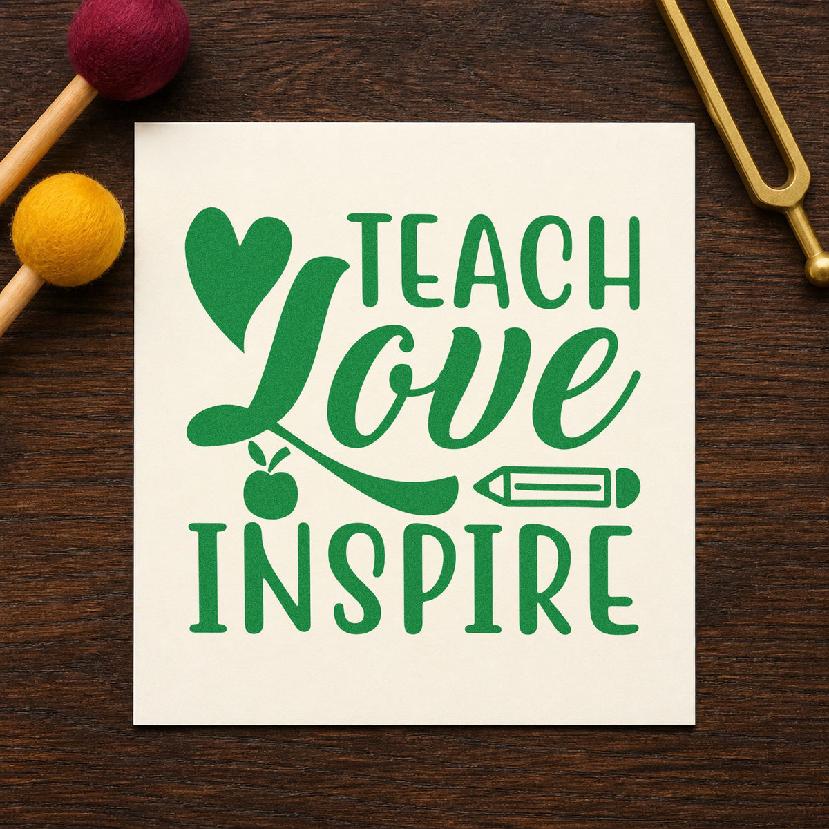 Teach Love Inspire Icons craft stamp imprint in green ink on a handmade project, one idea being signing sheet pages.