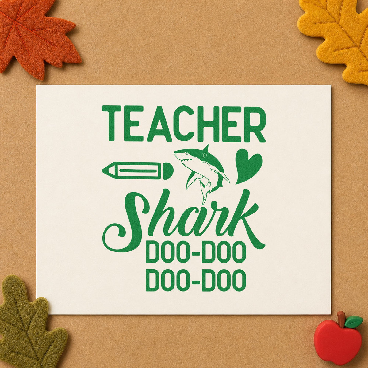 Teacher Shark Doo Doo craft stamp imprint in green ink on a handmade project, one idea being framed soft play.