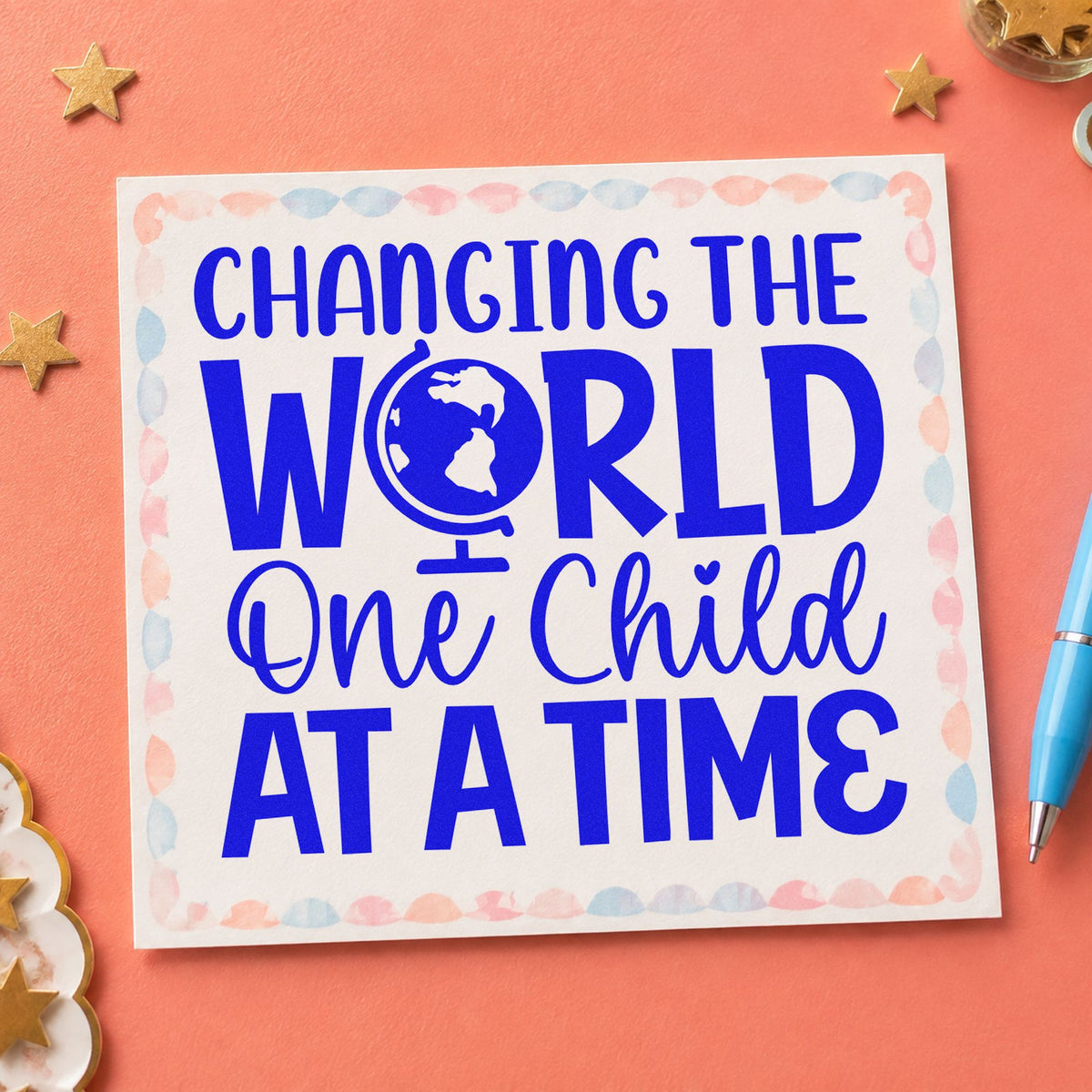 Changing World One Child craft stamp imprinted in blue ink on paper, a design suited to receipt book seals.