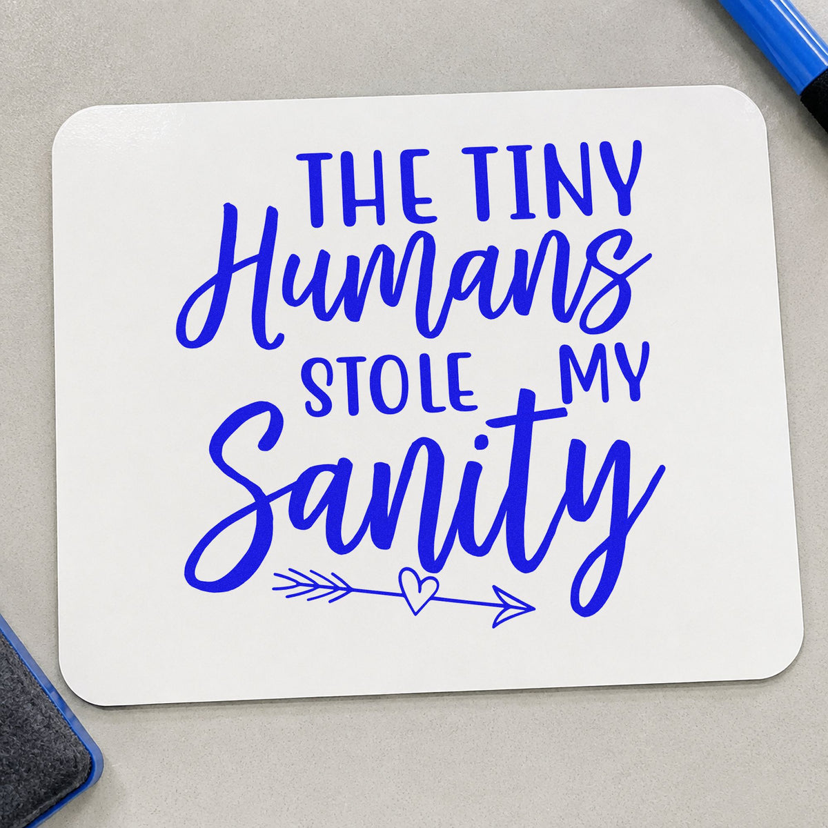 Tiny Humans Stole Sanity craft stamp imprinted in blue ink on paper, a design suited to wine box seals.
