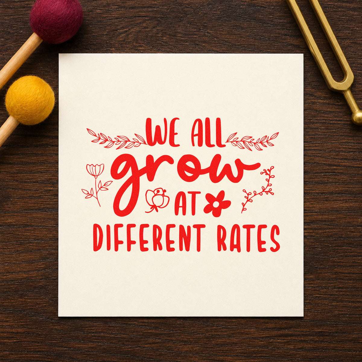 We Grow At Different Rates rubber stamp shown in red ink, stamped for projects such as parent meeting notes.