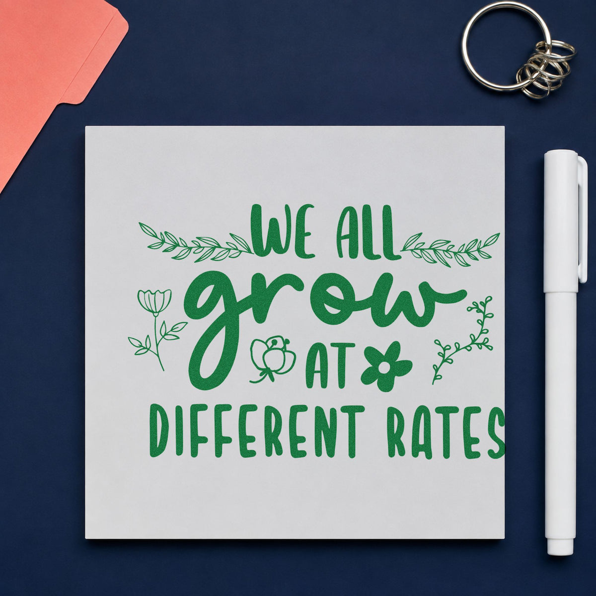 We Grow At Different Rates craft stamp imprint in green ink on a handmade project, one idea being framed nurture room.