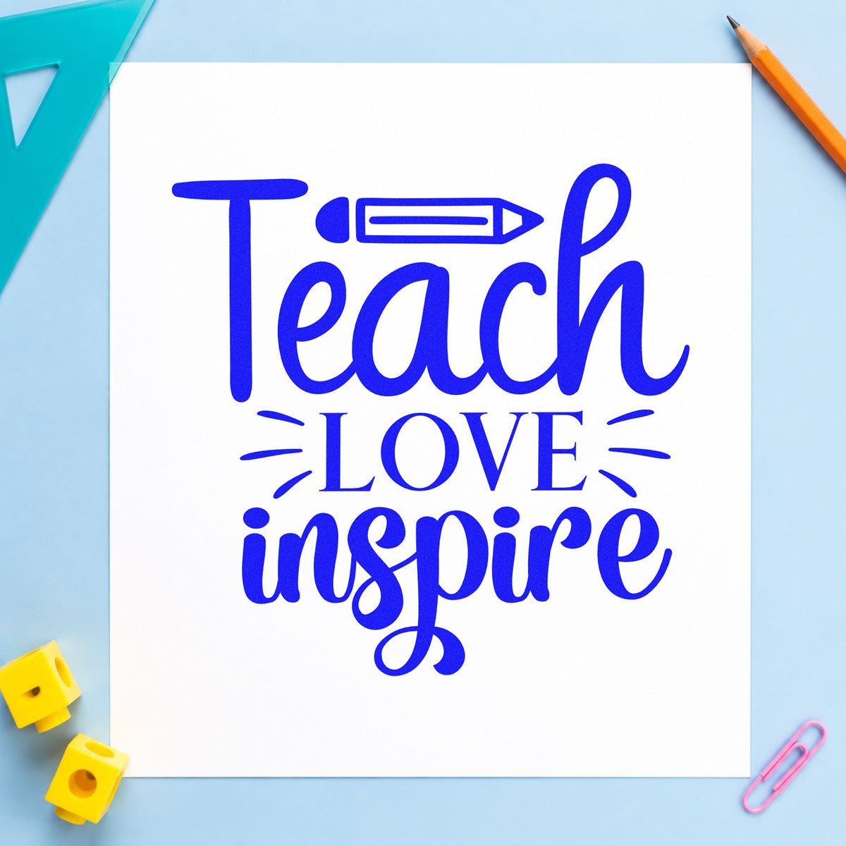 Teach Love Inspire Pencil craft stamp imprinted in blue ink on paper, a design suited to ink bottle seals.