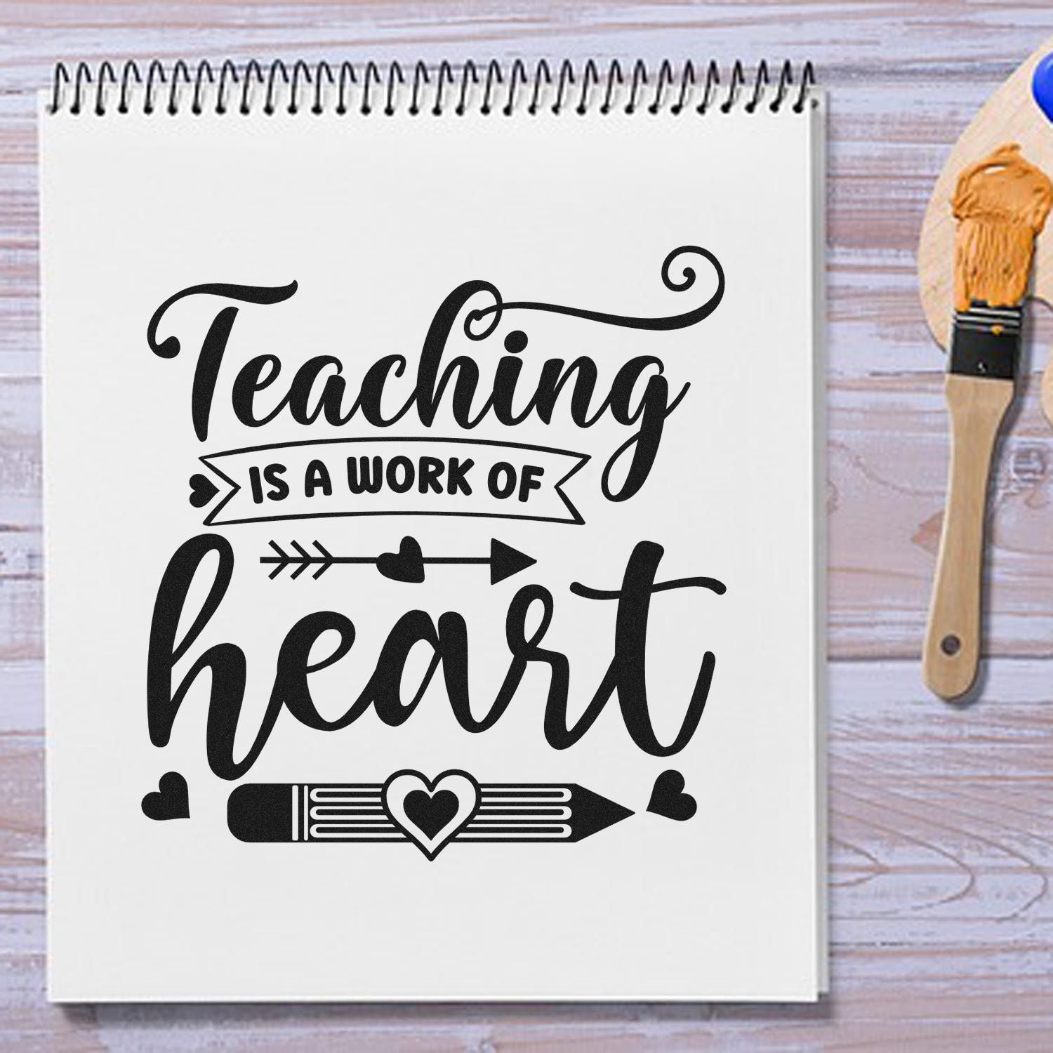 Teaching is a Work of Heart rubber stamp design on notebook, perfect for handmade teacher gifts and craft projects.