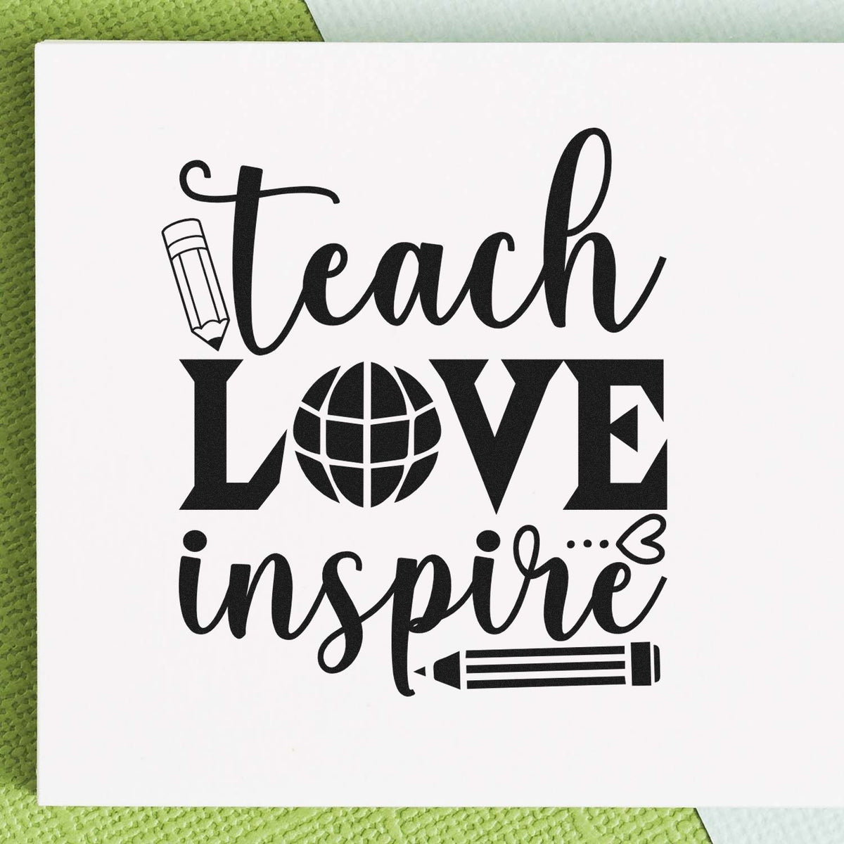 Premium Wooden Teach Love Inspire Globe Pencil Stamp - Vintage Pro imprint stamped in black ink. "Teach Love Inspire" replaces the O in "Love" with a globe and includes pencils.