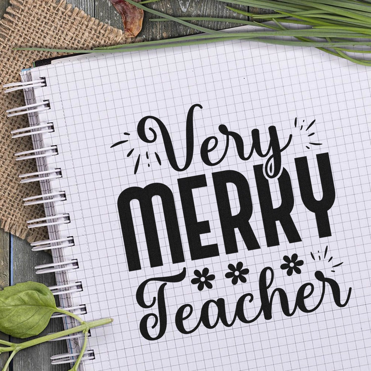 Very Merry Teacher Premium Wooden Stamp - Vintage Pro imprint stamped in black ink. "Very Merry Teacher" is decorated with flower-like asterisks and celebratory strokes.